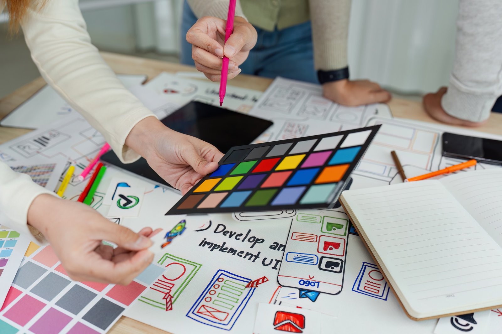 team of UI UX web designer are working together to develop mobile responsive websites with UI UX